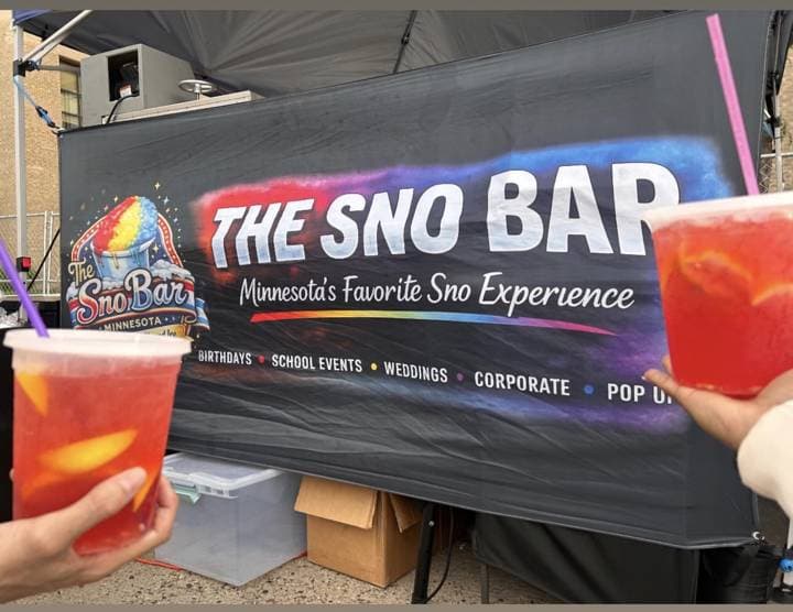 Two Sno Bar lemonades in front of the banner