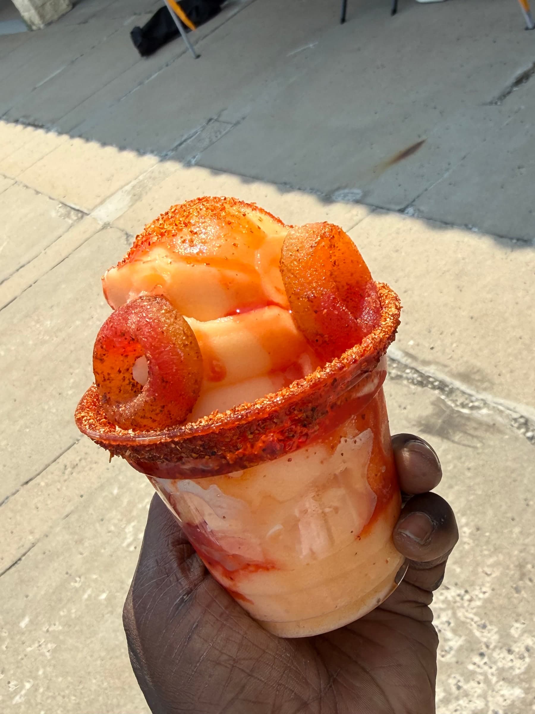 A chamoy-rimmed cup loaded with gummy rings