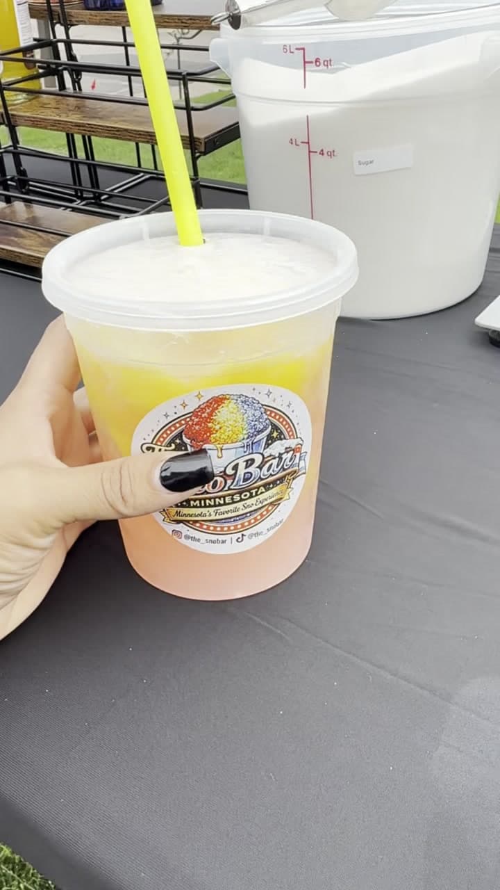 A cup of frozen lemonade with the Sno Bar logo