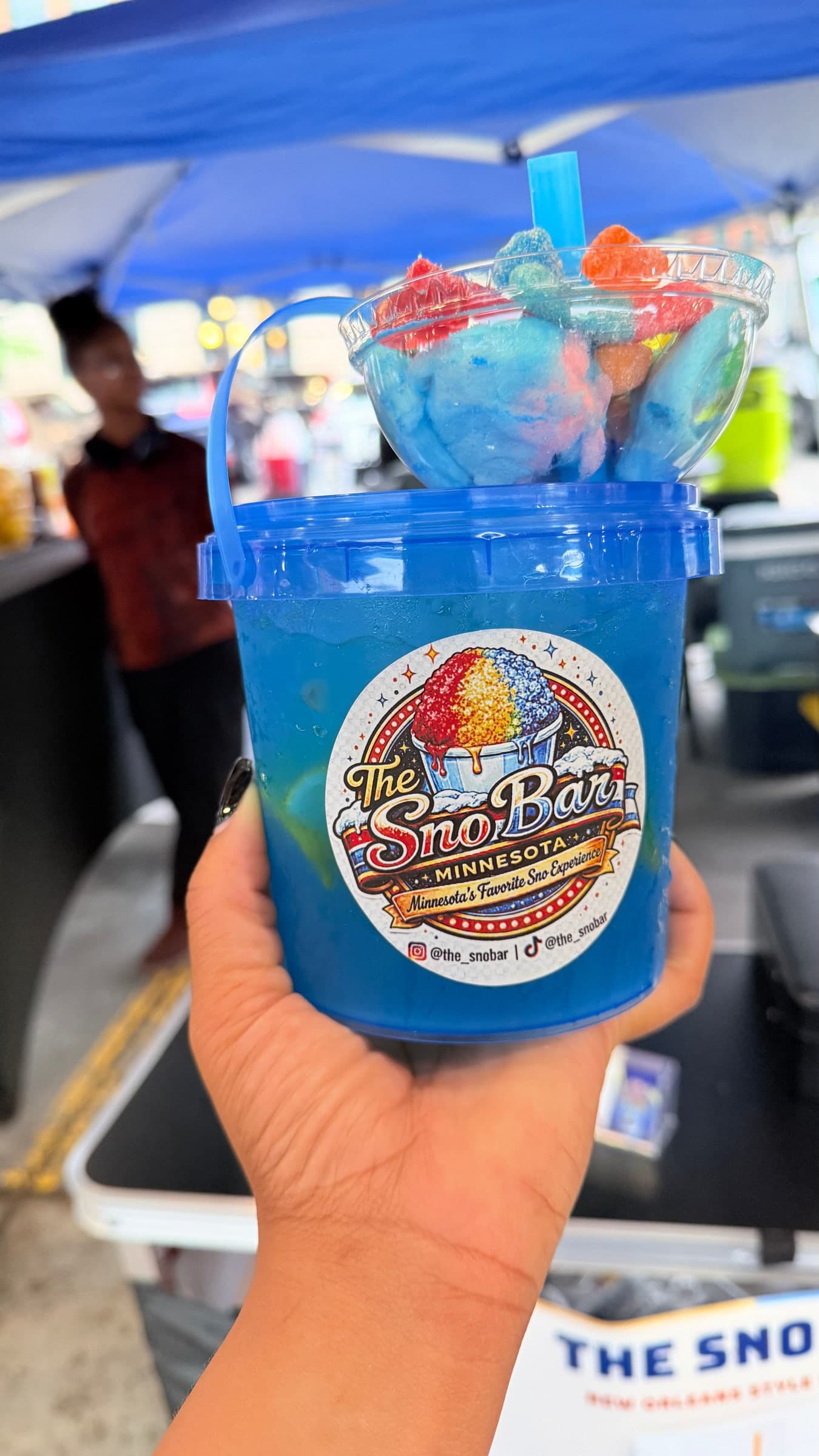The Sno Bucket, blue with candy and cotton candy on top